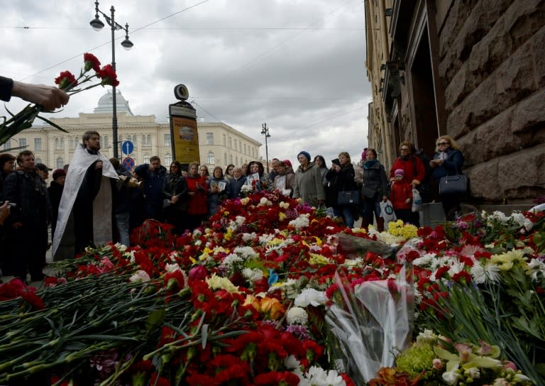 An Orthodox priest leads a service in memory of the victims of April 3 metro blast outside Technological Institute station in Saint Petersburg on April 5, 2017