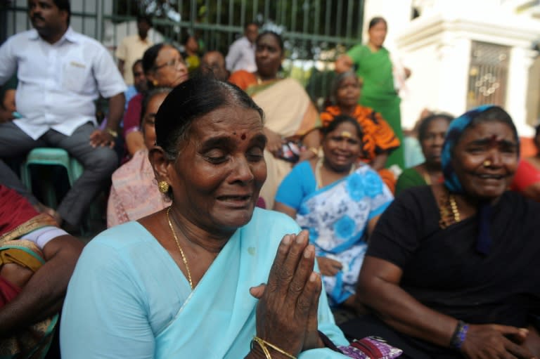 A supporter of Tamil Nadu state leader Jayalalithaa Jayaram cries as she prays in front of a hospital in Chennai, on December 5, 2016