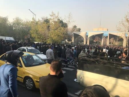 People protest near the university of Tehran, Iran December 30, 2017 in this picture obtained from social media. REUTERS