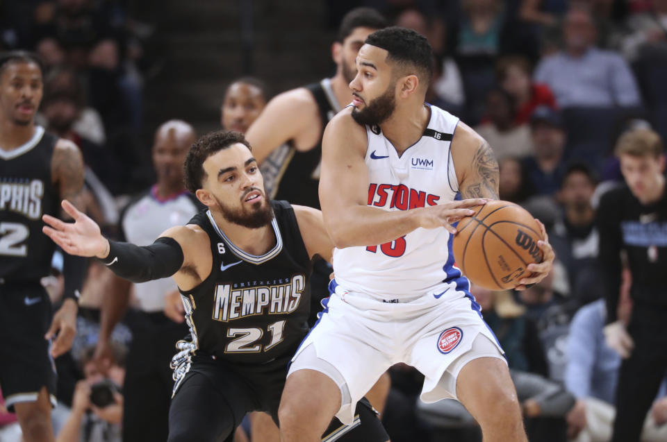 Memphis Grizzlies guard Tyus Jones (21) defends against Detroit Pistons guard Cory Joseph (18) during the first half of an NBA basketball game Friday, Dec. 9, 2022, in Memphis, Tenn. (AP Photo/Nikki Boertman)