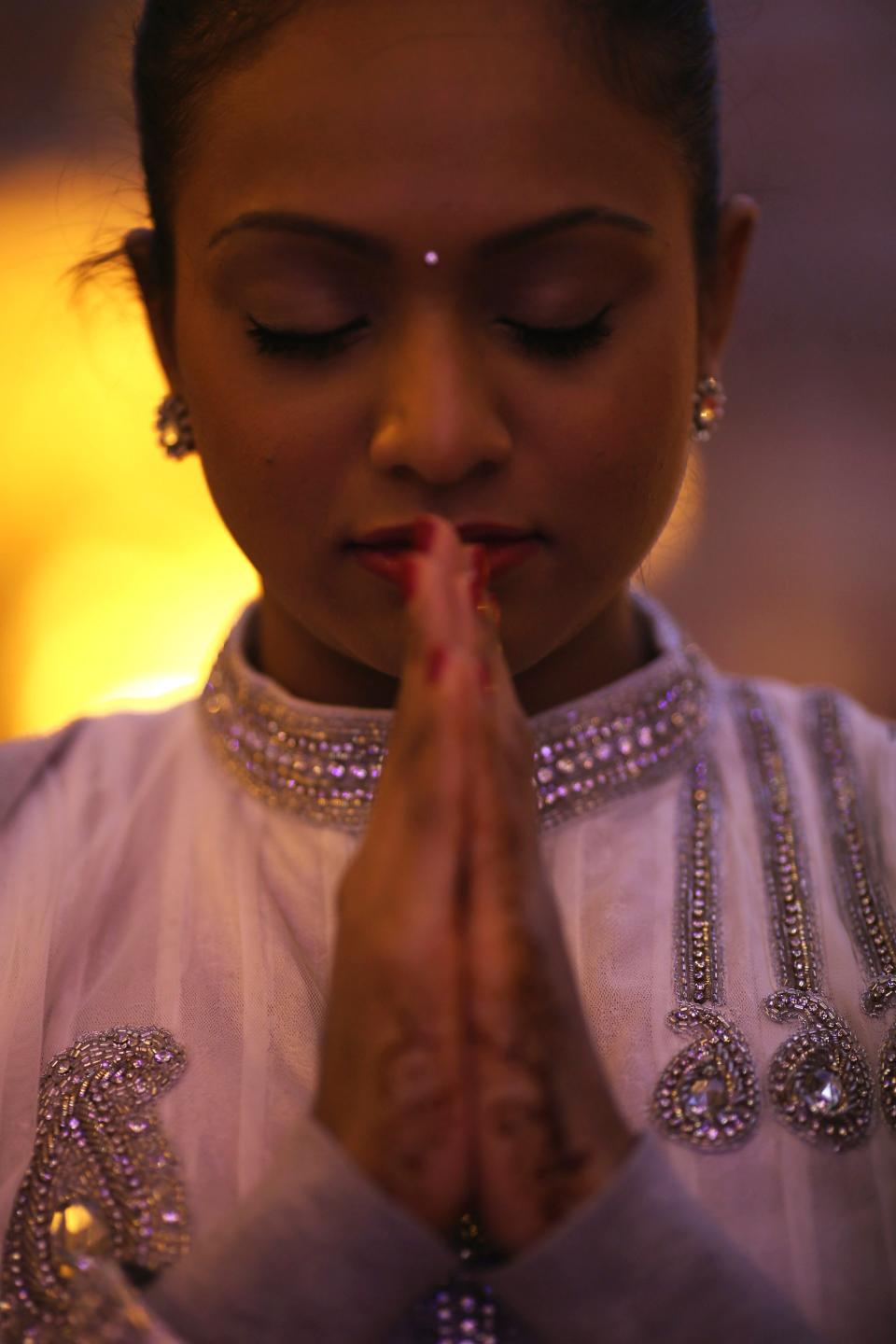 LONDON, ENGLAND - NOVEMBER 14: A woman prays in a shrine as Sadhus and Hindus celebrate Diwali at the BAPS Shri Swaminarayan Mandir on November 14, 2011 in London, England. Diwali, which marks the start of the Hindu New Year, is being celebrated by thousands of Hindu men women and children in the Neasden mandir, which was the first traditional Hindu temple to open in Europe. (Photo by Dan Kitwood/Getty Images)