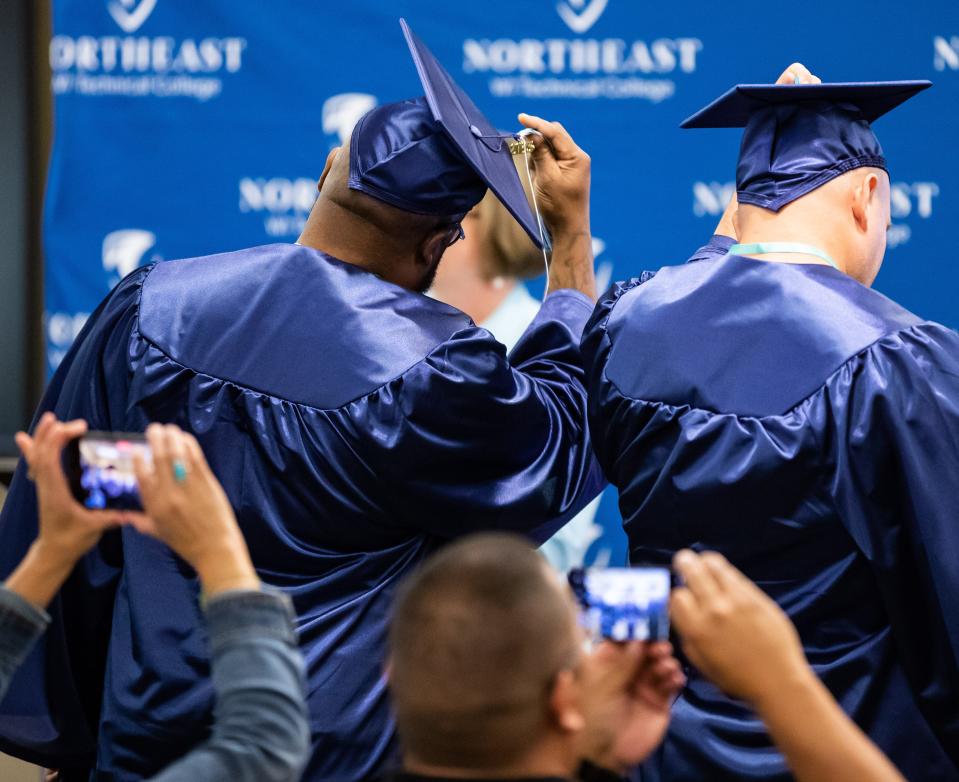 Students from the Sanger B. Powers Correctional Center move their tassels from the right to the left side of their caps during their graduation ceremony at Northeast Wisconsin Technical College, where they earned certificates in Industrial Maintenance, on Thursday in Green Bay.