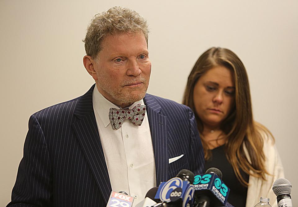 Attorney Sam Davis (podium) joined by Erica Murphy (right) speaks at a press conference two days after charges were filed against a Delaware State Police trooper in the attack of two teenagers in August.