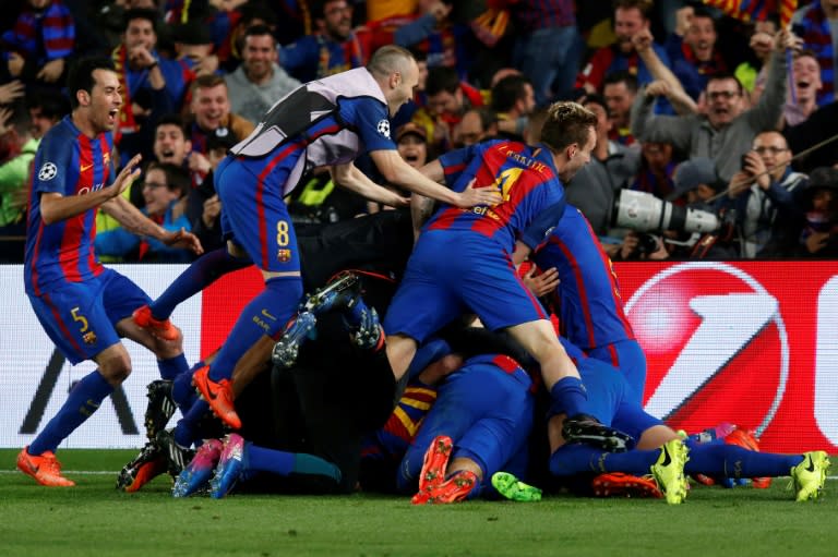 Barcelona players pile onto Sergi Roberto after his winning goal in the Champions League match against Paris Saint-Germain at the Nou Camp stadium on March 8, 2017