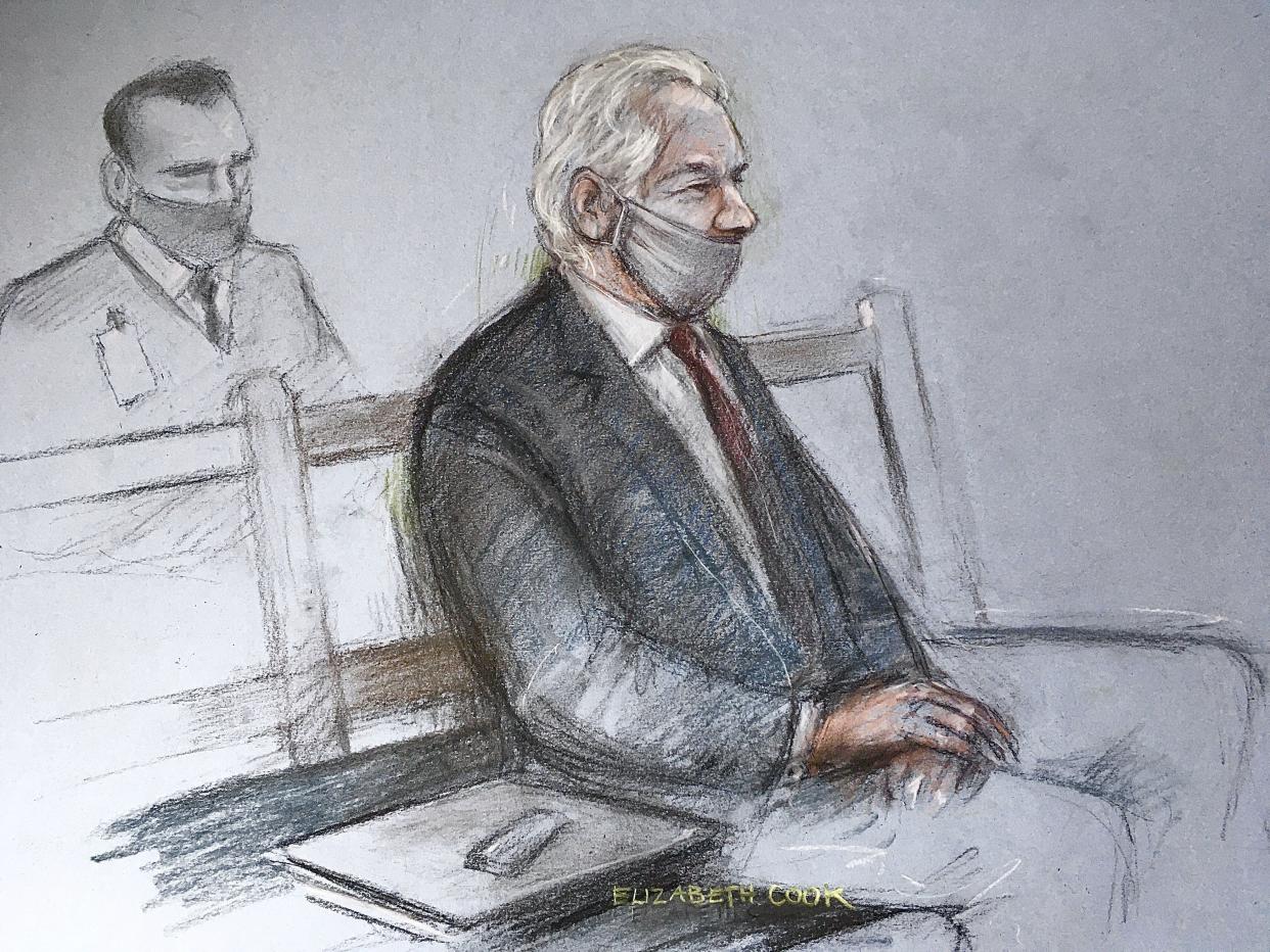 This is a court artist sketch by Elizabeth Cook of Julian Assange appearing at the Old Bailey in London for the ruling in his extradition case, on Monday, Jan. 4, 2021.