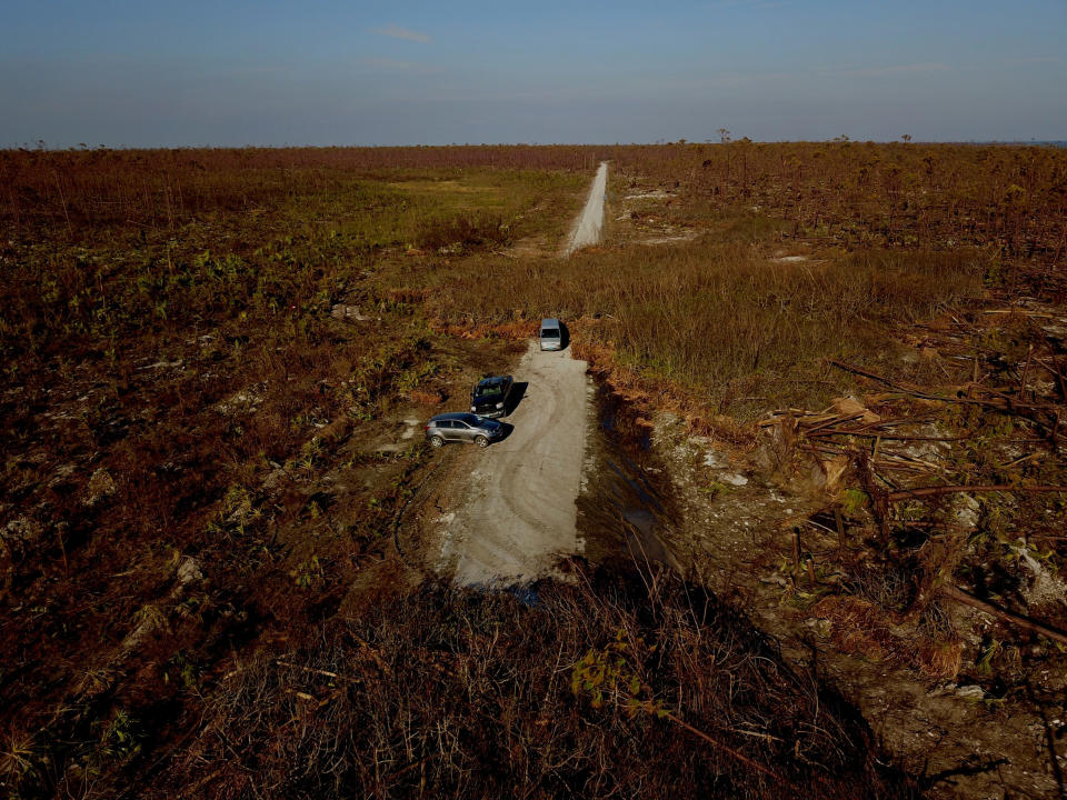 Cars stand stranded on a road damaged by Hurricane Dorian in High Rock, Grand Bahama, Bahamas, Sept. 6, 2019. | Ramon Espinosa—AP