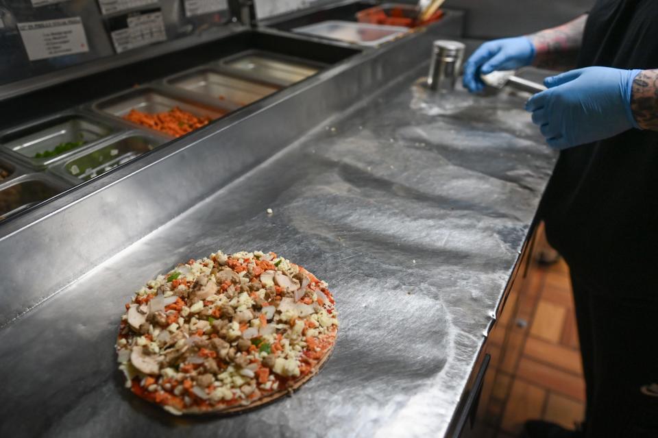 A freshly prepared "Royal Feast" pizza from Sir Pizza in Old Town, before it's placed in the oven.
