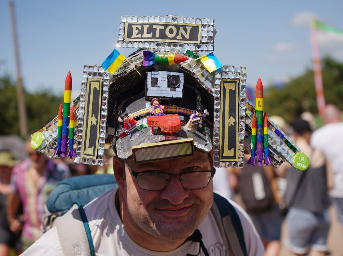 Festivalgoer Alex McGuire, from Taunton, wearing an Elton John Pyramid Stage hat at the Glastonbury Festival (PA)