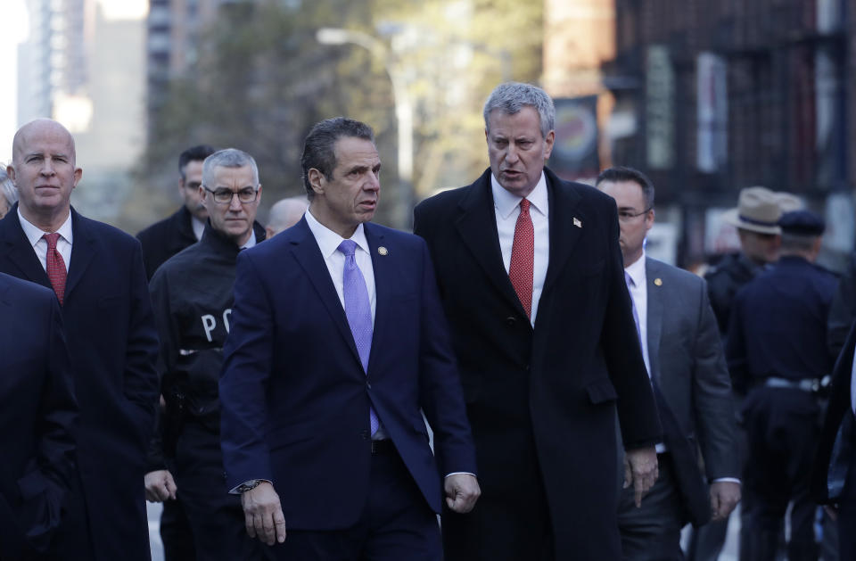 New York Gov. Andrew Cuomo, center, and Bill de Blasio arrive for a news conference outside the Port Authority Bus Terminal in New York City. (Photo: Mark Lennihan/AP)