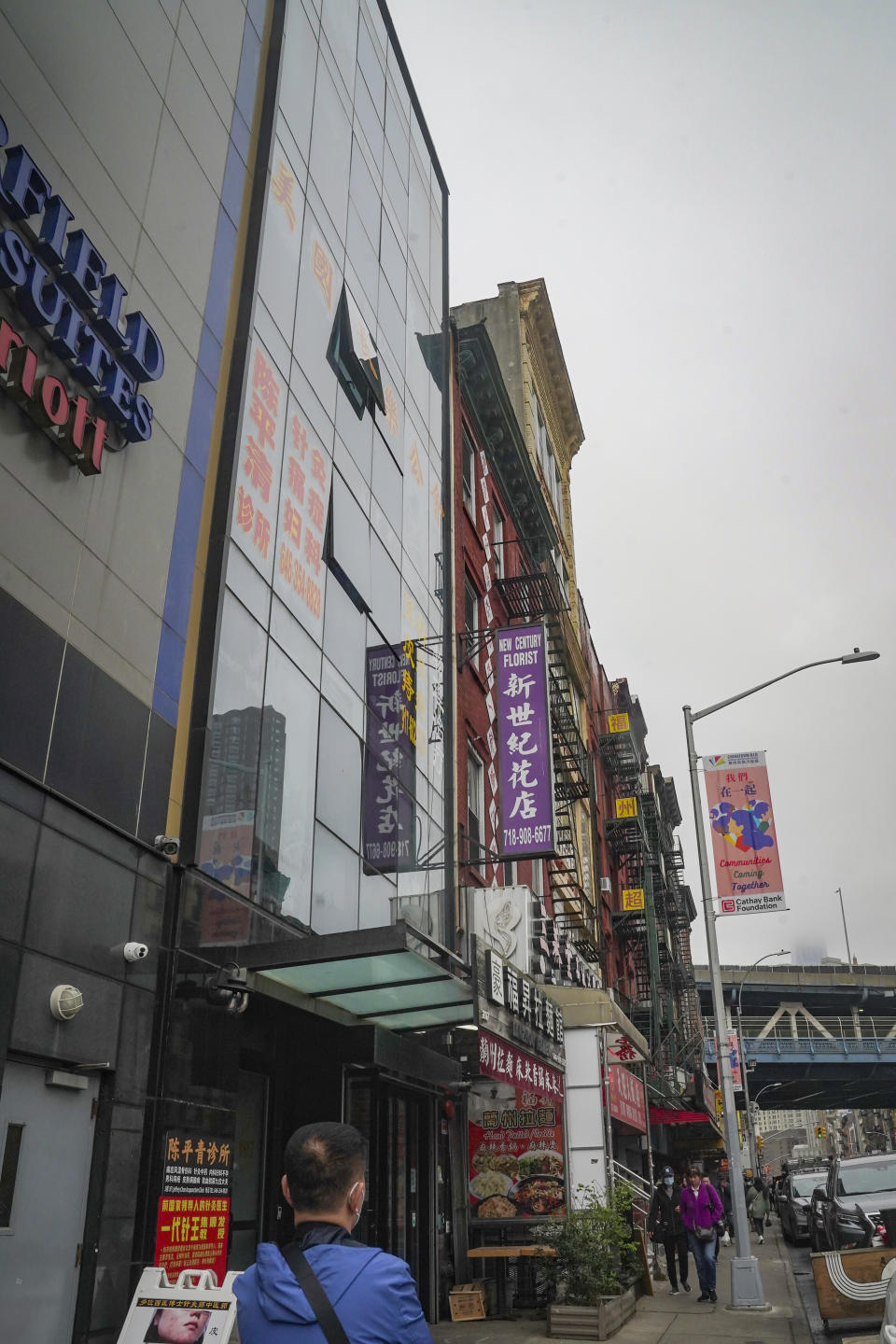 A six story glass facade building, second from left, is believed to be the site of a foreign police outpost for China in New York's Chinatown, Monday April 17, 2023. Justice Department officials say two men have been arrested on charges that they helped establish a secret police outpost in New York City on behalf of the Chinese government. (AP Photo/Bebeto Matthews)