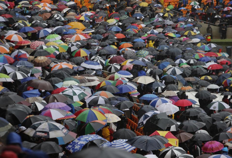 A sea of umbrellas in the arena as rain lashes down during the memorial service for former South African president Nelson Mandela at the FNB Stadium in Soweto, near Johannesburg, South Africa, Tuesday Dec. 10, 2013. (AP Photo/Tsvangirayi Mukwazhi)
