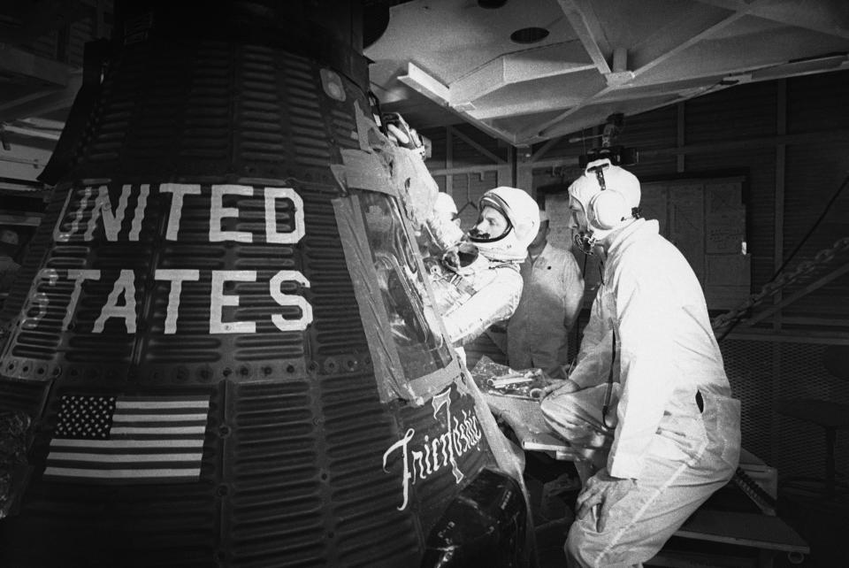 FILE - In this Jan. 2, 1962, file photo, astronaut John Glenn climbs into the "Friendship 7" Mercury capsule at Cape Canaveral, Fla. Glenn's birthplace and childhood hometown in Ohio are celebrating what would have been the history-making astronaut and U.S. senator's 100th birthday with a three-day festival from July 16 through July 18, 2021. (AP Photo/File)