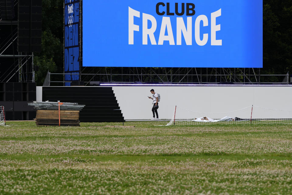 Una persona camina cerca del escenario en el Club Francia en el Parc de la Villette renombrado temporalmente Parc des Nations antes de los Juegos Olímpicos de Verano de 2024, el martes 23 de julio de 2024, en París, Francia. (Foto AP/Natacha Pisarenko)