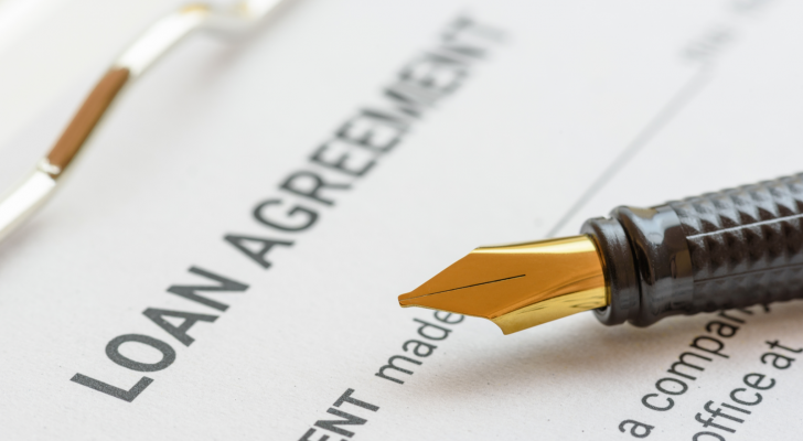 Picture of a loan agreement with a pen.