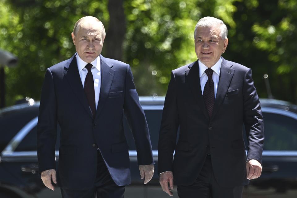 Russian President Vladimir Putin, left, and Uzbek President Shavkat Mirziyoyev walk prior to their talks at the state residence in Tashkent, Uzbekistan, Monday, May 27, 2024. (Sergei Bobylev, Sputnik, Kremlin Pool Photo via AP)