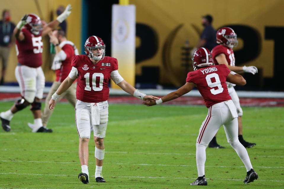 MIAMI GARDENS, FL - JANUARY 11: Alabama Crimson Tide quarterback Mac Jones (10) is greeted by Alabama Crimson Tide quarterback Bryce Young (9) during the CFP National Championship game between the Alabama Crimson Tide and the Ohio State Buckeyes on January 11, 2021 at Hard Rock Stadium in Miami Gardens, Fl. (Photo by David Rosenblum/Icon Sportswire via Getty Images)