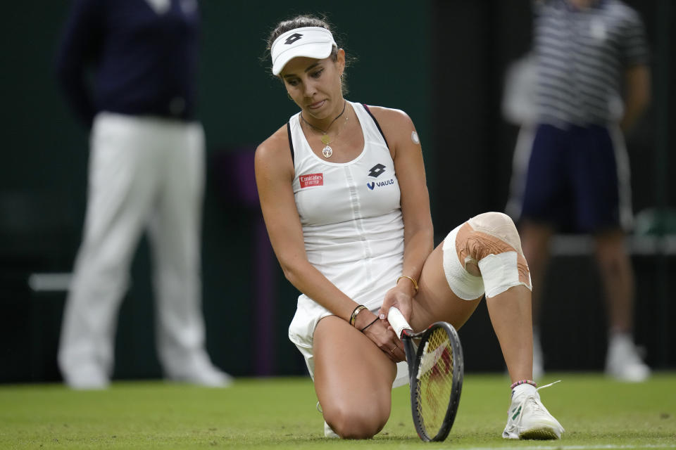 Romania's Mihaela Buzarnescu reacts after missing a shot against Coco Gauff of the US in a second round women's singles match on day four of the Wimbledon tennis championships in London, Thursday, June 30, 2022. (AP Photo/Kirsty Wigglesworth)