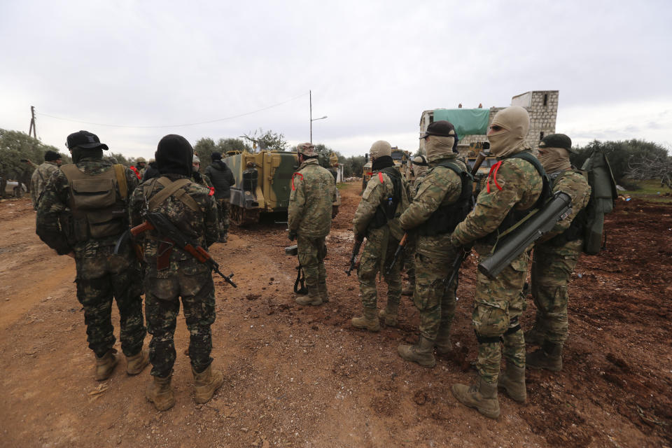 Turkish backed Syrian fighters prepare to go to frontline in Idlib province, Syria. Tuesday, Feb. 11, 2020. The fighting on Tuesday concentrated near the village of Nairab as rebels, with the backing of Turkish artillery, tried to retake the village that they lost last week, according to opposition activists. (AP Photo/Ghaith Alsayed)