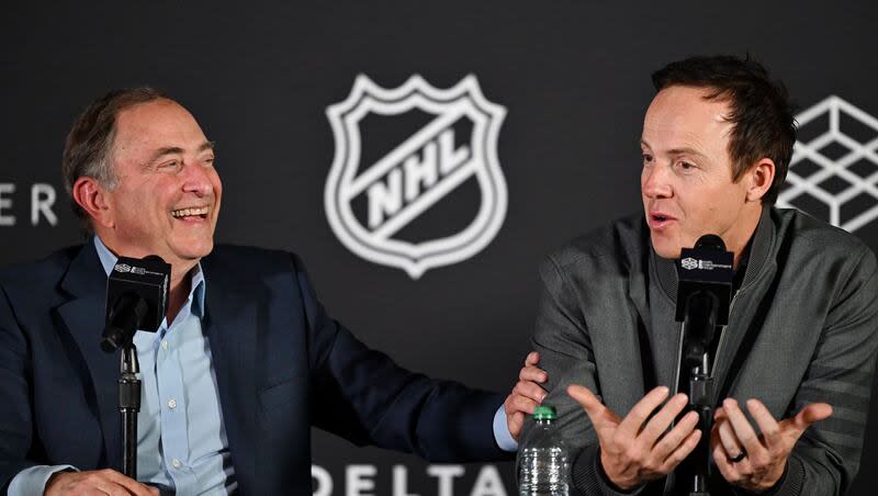 NHL Commissioner Gary Bettman laughs as Ryan Smith, co-founder and chairman of Smith Entertainment Group, speaks at a press conference at the Delta Center in Salt Lake City to announce that the NHL would be coming to Utah on Friday, April 18, 2024.