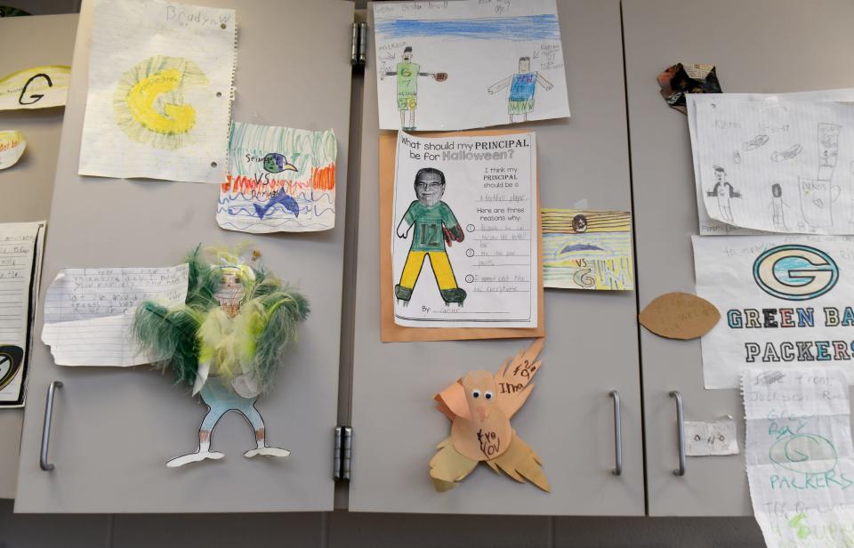 Artwork decorates Northwest Primary Principal James LaRiccia's office. Among the artwork is a picture of him dressed as a football player drawn by a student who thought he should dress up as a football player for Halloween because he is good at throwing the ball. LaRiccia plays football with his students at recess.