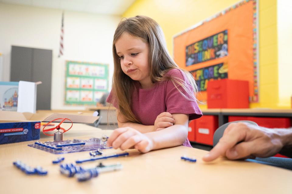 Vanessa Marinelli-Smith, 6, focuses on a snap circuit board kit while figuring it out alongside her dad Rick Smith at Johnstown Elementary School on Tuesday. Rick Smith is an engineer, Vanessa will be entering first grade at the school.