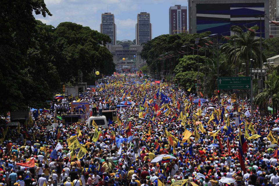 Supporters of opposition presidential candidate Henrique Capriles gather during a campaign rally in Caracas, Venezuela, Sunday, Sept. 30, 2012. Presidential elections in Venezuela are scheduled for Oct. 7. (AP Photo/Ariana Cubillos)