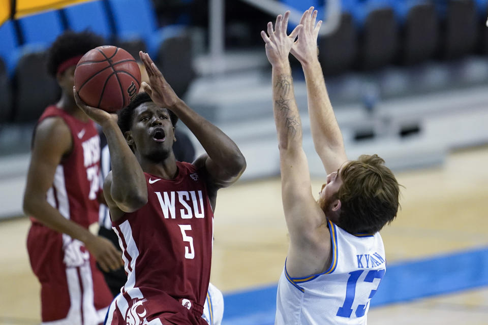 Washington State guard T.J. Bamba (5) shoots against UCLA guard Jake Kyman (13) during the first half of an NCAA college basketball game Thursday, Jan. 14, 2021, in Los Angeles. (AP Photo/Ashley Landis)