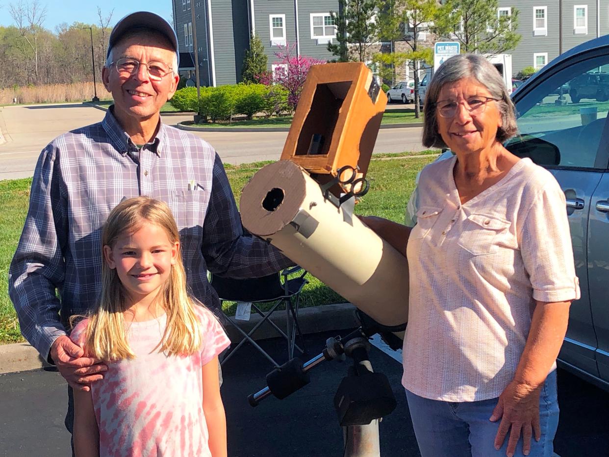 John and Rita Waller, from Edelstein, and granddaughter Charlotte, 7, as they set up a shielded telescope in a hotel parking lot in Carbondale, on a journey with their son, daughter-in-law, and five grandchildren to see a total eclipse on Monday, April 8, 2024.