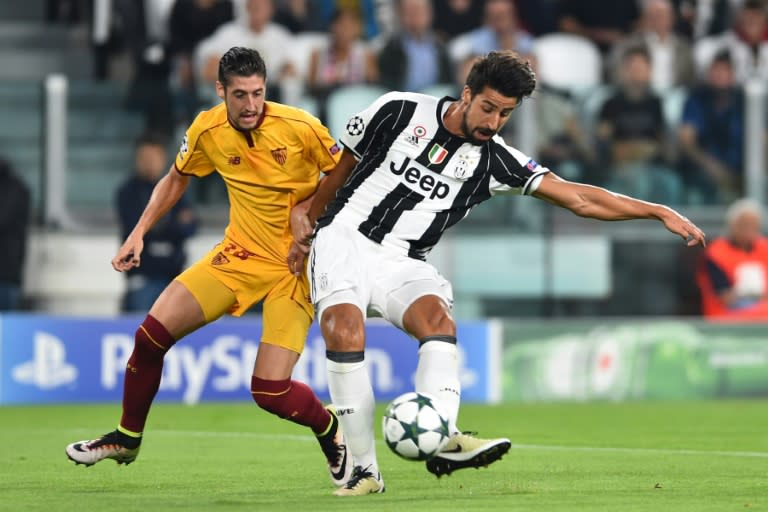 Juventus' Sami Khedira (R) tussles with Sevilla's Sergio Escudero in Turin on September 14, 2016