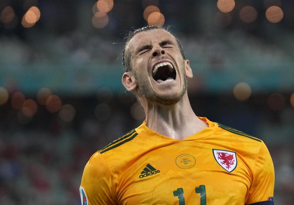Wales' Gareth Bale celebrates after his teammate Wales' Connor Roberts scored his sides second goal during the Euro 2020 soccer championship group A match between Turkey and Wales the Baku Olympic Stadium in Baku, Azerbaijan, Wednesday, June 16, 2021. (AP Photo/Darko Vojinovic, Pool)