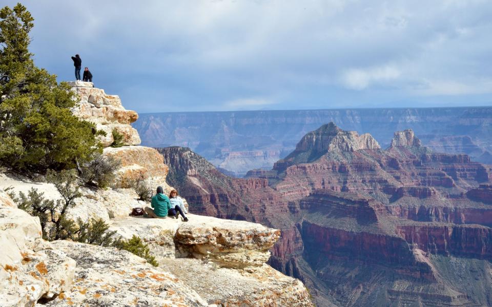 Tourists take photos from the North Rim of the Grand Canyon - MLADEN ANTONOV/AFP