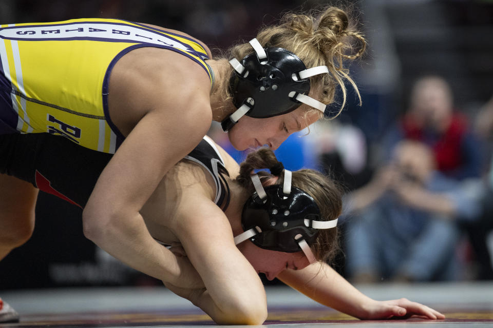 Palisades' Savannah Witt, top, wrestles Hempfield's Cleona O'Brien, bottom, during the first found of the PIAA High School Wrestling Championships in Hershey, Pa., Thursday, March 7, 2024. Girls’ wrestling has become the fastest-growing high school sport in the country. (AP Photo/Matt Rourke)