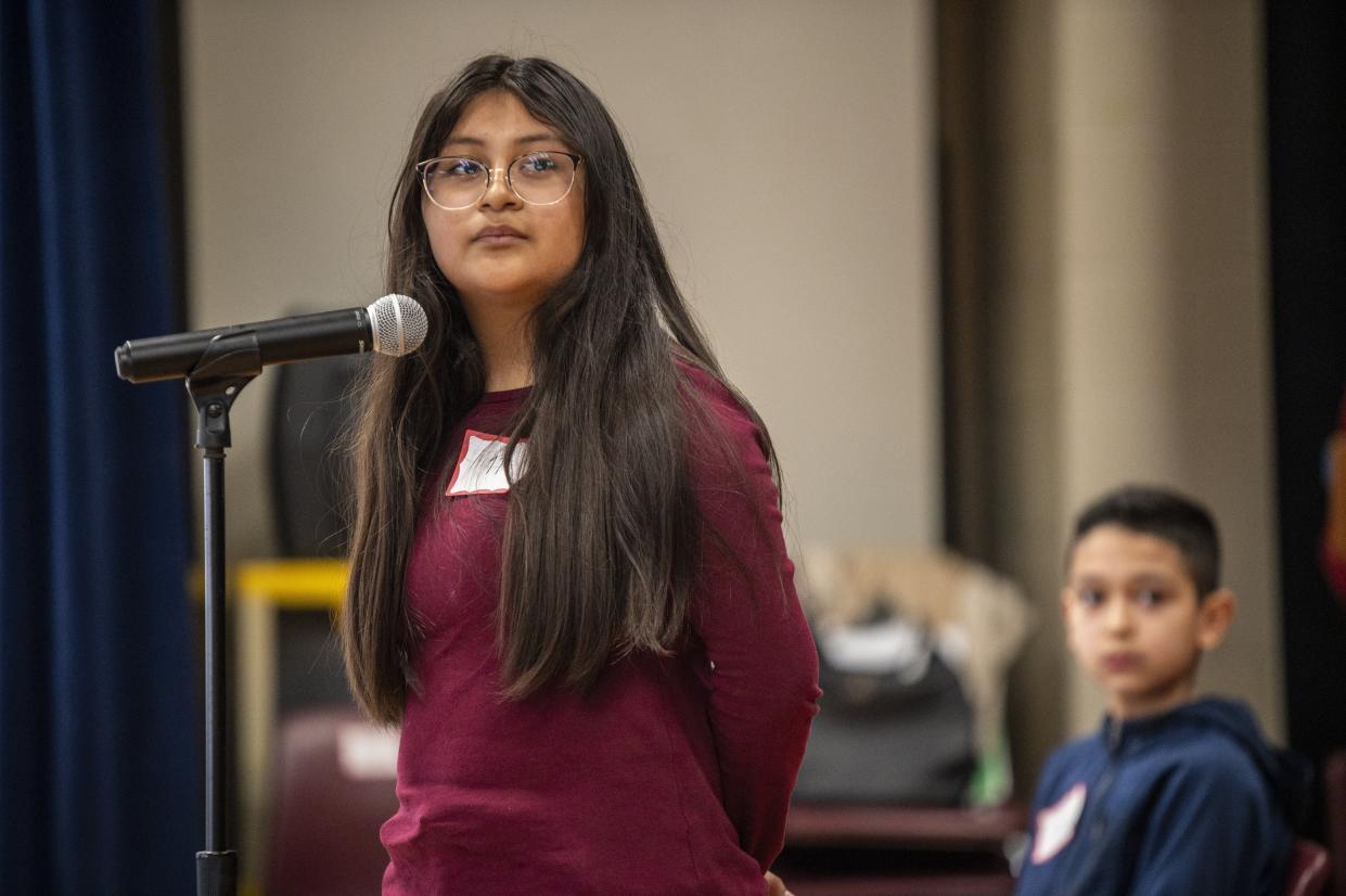Alisson Hernandez listens to the word she will have to spell at the Spanish spelling bee. Alisson finished second in the competition.