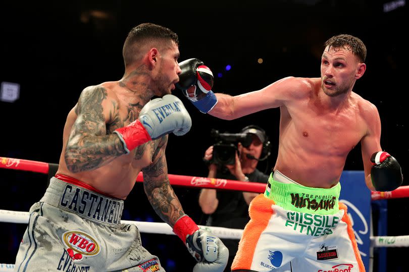 Photo shows Sean McComb (right) exchanging blows with Arnold Barboza Jr