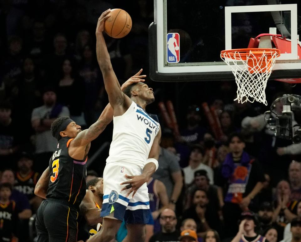 Minnesota Timberwolves guard Anthony Edwards (5) dunks past Phoenix Suns guard Bradley Beal (3) during game 4 of the Western Conference first round series at Footprint Center on Sunday, April 28, 2024.