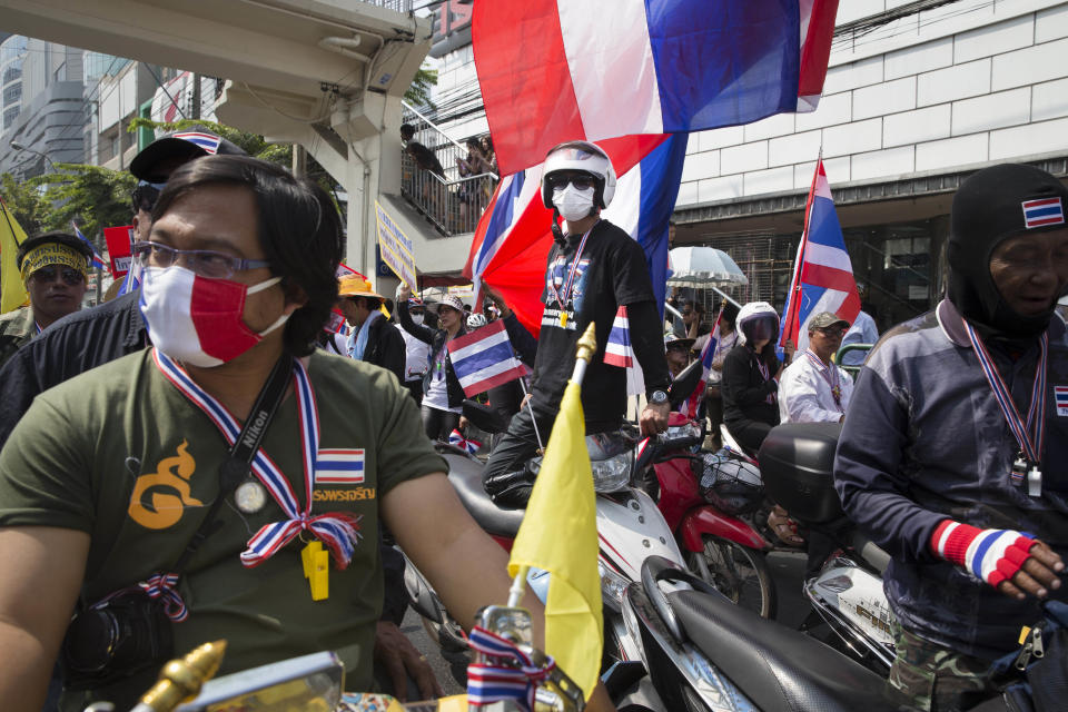 Anti-government protesters rest on their motorbikes during a march, Sunday, Jan. 19, 2014, in Bangkok. Two explosions shook an anti-government demonstration site in Thailand's capital on Sunday, wounding at least 28 people in the latest violence to hit Bangkok as the nation's increasingly volatile political crisis drags on. (AP Photo/John Minchillo)