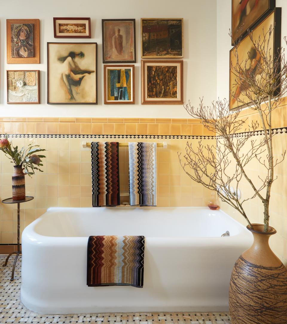 A salon-style art hanging turns the bath into a mini-gallery. Towels by Missoni Home.