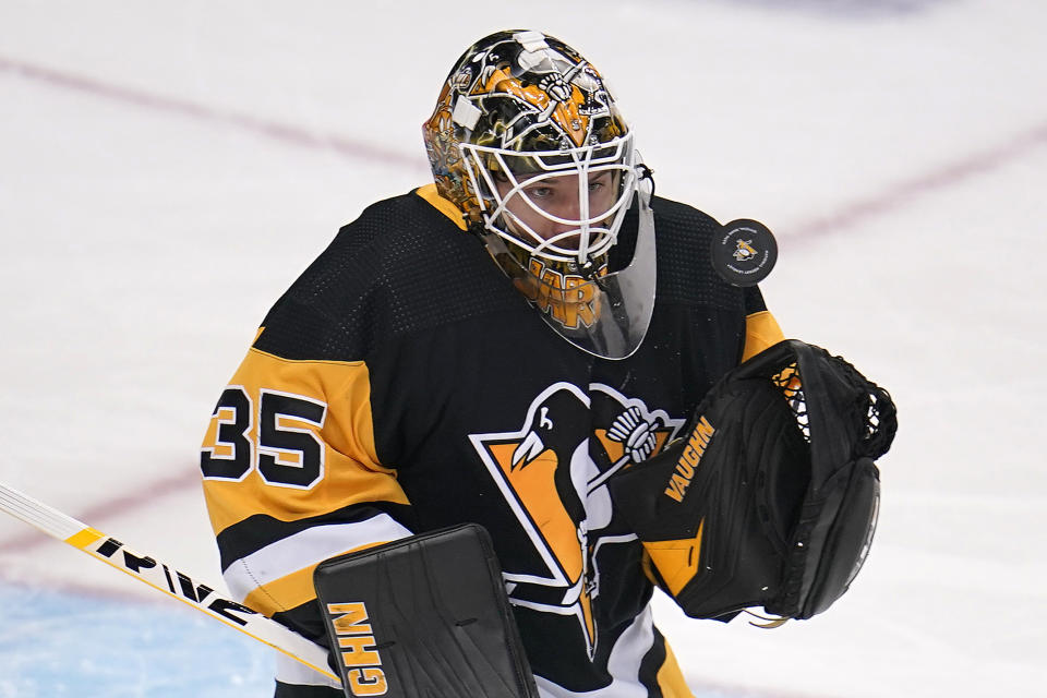 Pittsburgh Penguins goaltender Tristan Jarry keeps his eye on a rebound during the first period of the team's NHL hockey game against the Vancouver Canucks in Pittsburgh, Wednesday, Nov. 24, 2021. (AP Photo/Gene J. Puskar)