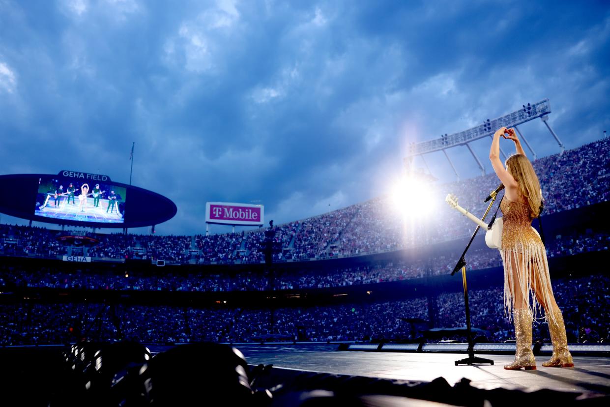 Taylor Swift makes a heart symbol with her hands on stage at The Eras Tour