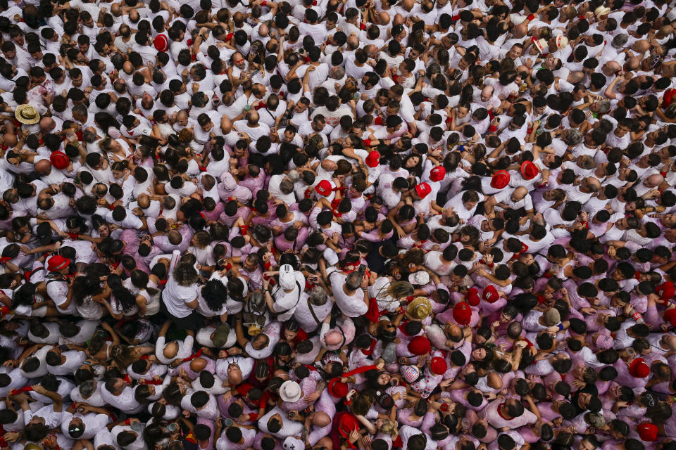 Revellers dressed in red and white fill the town hall square during the 'Chupinazo' rocket, which marks the official opening of the 2023 San Fermín fiestas in Pamplona, Spain, Thursday, July 6, 2023. (AP Photo/Alvaro Barrientos)