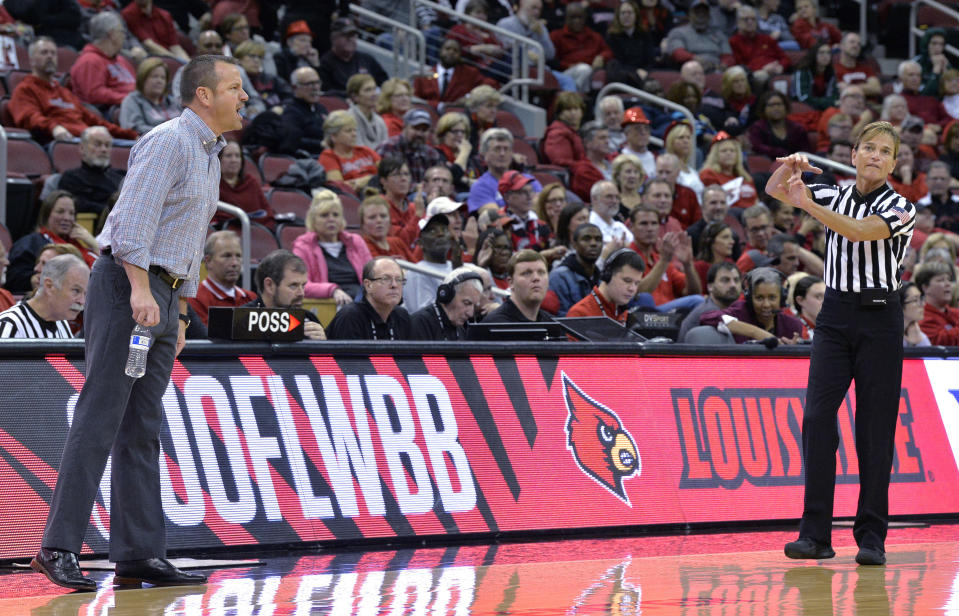 FILE - Referee Dee Kantner gives Louisville coach Jeff Walz a technical foul during the second half of the team's NCAA college basketball game against Nebraska in Louisville, Ky., Thursday, Nov. 29, 2018. Louisville won 85-68. Kantner, a veteran referee of women’s games who works for multiple conferences, finds it frustrating to have to justify equal pay. “If I buy an airline ticket and tell them I’m doing a women’s basketball game they aren’t going to charge me less,” she said. (AP Photo/Timothy D. Easley, File)