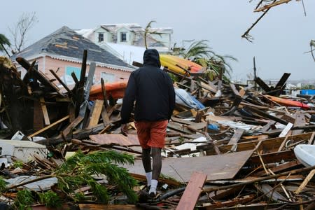 FILE PHOTO: A man walks through the rubble in the aftermath of Hurricane Dorian in Marsh Harbour