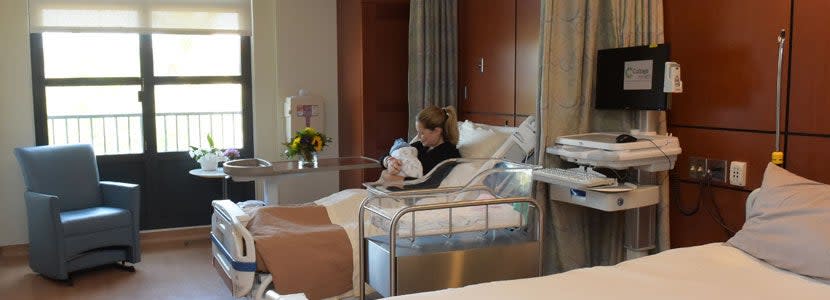 A woman pictured with her newborn in one of Santa Barbara Cottage Hospital’s birthing suites, in a photo released on their website (Santa Barbara Cottage Hospital)