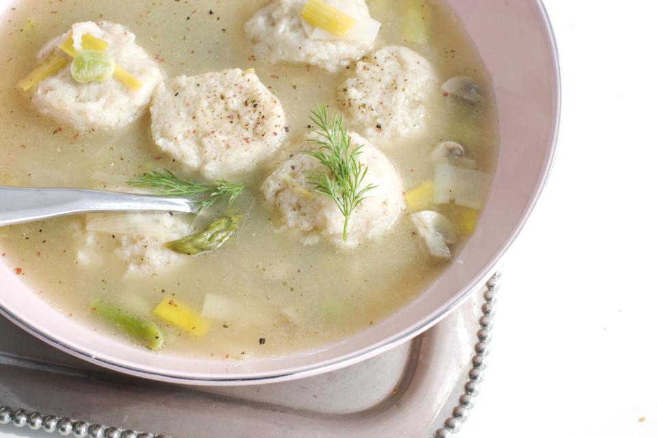 In this March 4, 2013 photo, spring vegetable soup with low-fat, high-flavor matzo balls is shown served in a bowl in Concord, N.H. (AP Photo/Matthew Mead)