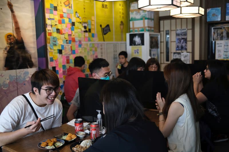 Customers sit inside a yellow restaurant called ''Mainichi'', during ''golden ween'' holiday by supporting local businesses with the pro-democracy views, in Hong Kong