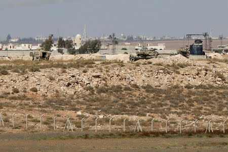 FILE PHOTO: Vehicles near Nasib border crossing between Jordan and Syria, are seen from Marafaq, Jordan, September 29, 2018. REUTERS/Muhammad Hamed/File Photo