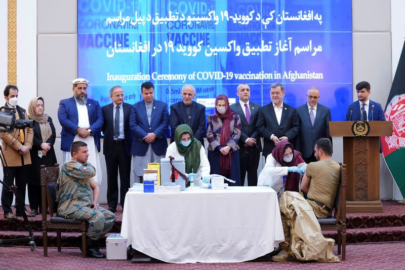 Members of Afghan security forces receive the first dose of AstraZeneca's COVID-19 vaccine from India, in Kabul