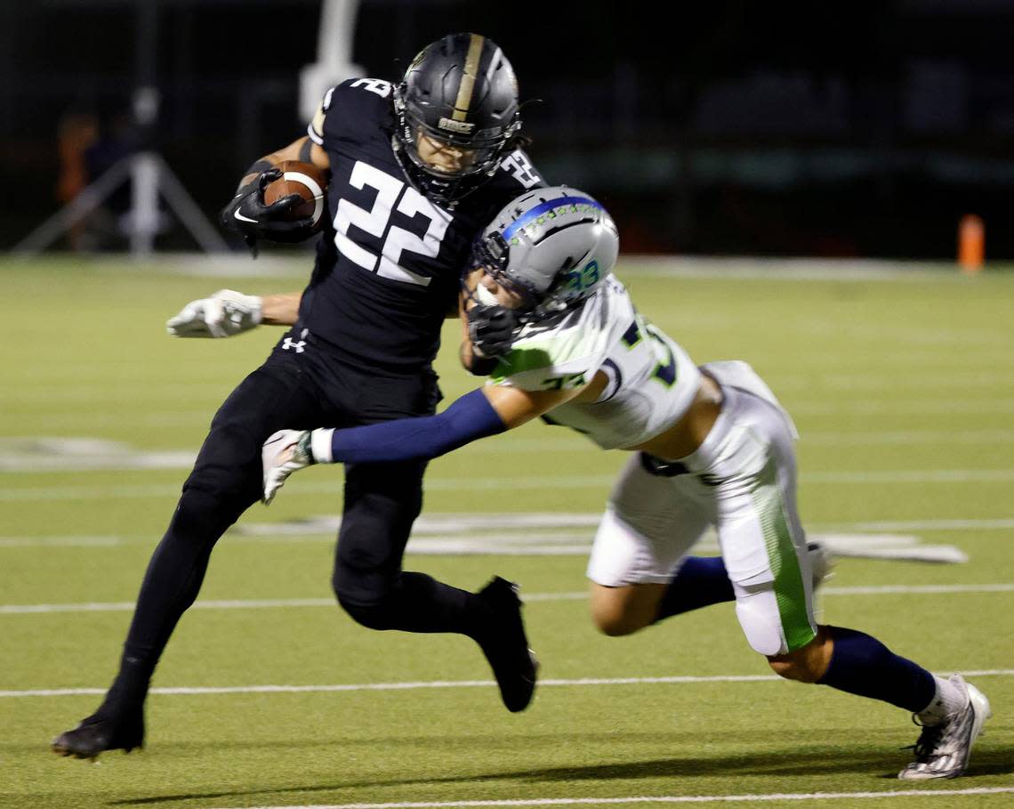 Keller Fossil Ridge running back Cameron Moran (22) attempts to avoid the tackle by Haslet Eaton safety Ben Self (33) in the first half of a UIL high school football game at Keller ISD Stadium in Keller, Texas, Thursday, Sept. 21, 2023. Eaton led 24-14 at the half. Bob Booth/Special to the Star-Telegram