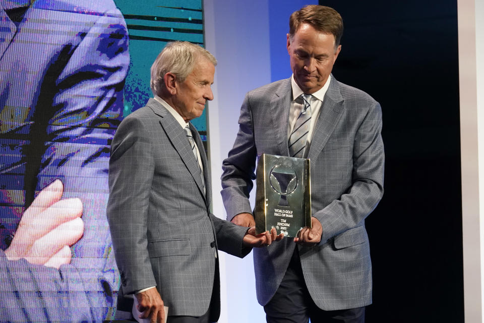 Former PGA Tour commissioner Tim Finchem, left, inducted into the World Golf Hall of Fame by Davis Love IIII Wednesday, March 9, 2022, in Ponte Vedra Beach, Fla. (AP Photo/Gerald Herbert)