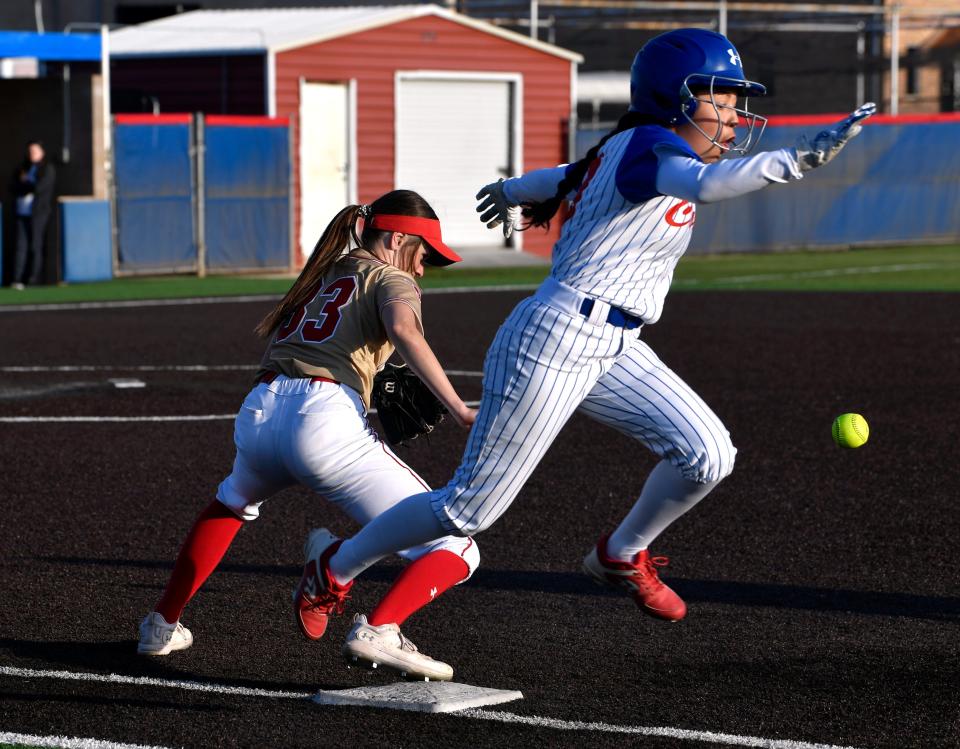 Cooper’s Nadia Garcia sprints across the first base bag as Lubbock Coronado’s Addison Andrews tries to recover the ball during Tuesday’s softball game at Cougar Diamond.